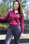 Model wears womens Performance Pull Over with Quarter Zip and long sleeves paired with gray and dapple full seat breeches while leaning on a fence