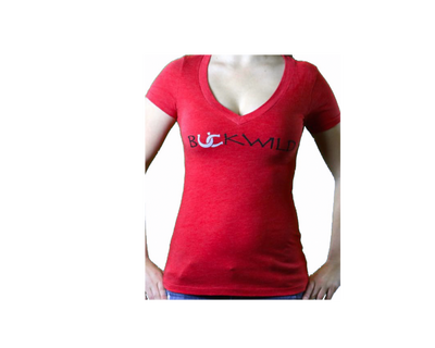 Model wears red v-neck t-shirt with Buckwild logo front.  Back of shirt reads "If you can see this, put me back on my horse" written upside down. 